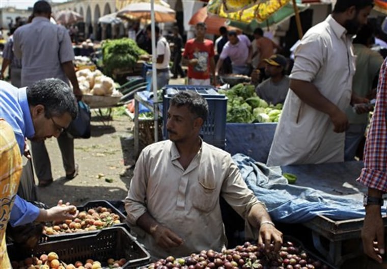 A street vendor talks to customer in a street market in the rebel-held Benghazi, Libya on Thursday.